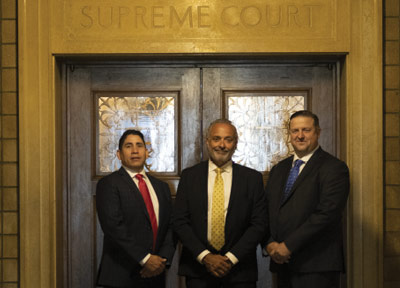 Photo of attorneys: Raul F. Guerra, Carlos A. Monzón and David V. Chipman.